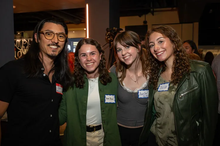 Four smiling attendees wearing name tags at the Boulder County Film Commission Fall Schmoozer