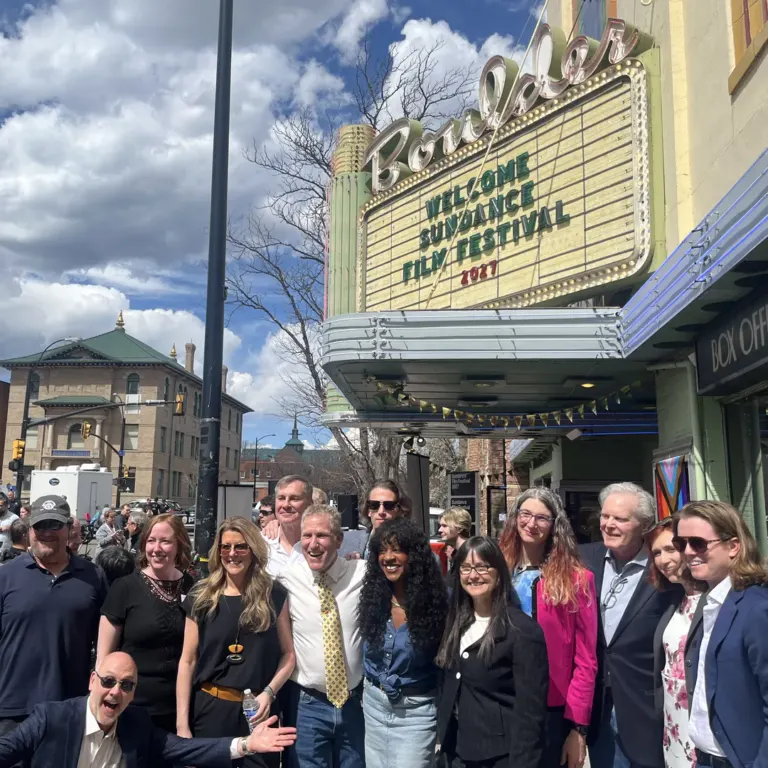 Community members gathered outside the Boulder Theater beneath its marquee reading “Welcome Sundance Film Festival 2027”